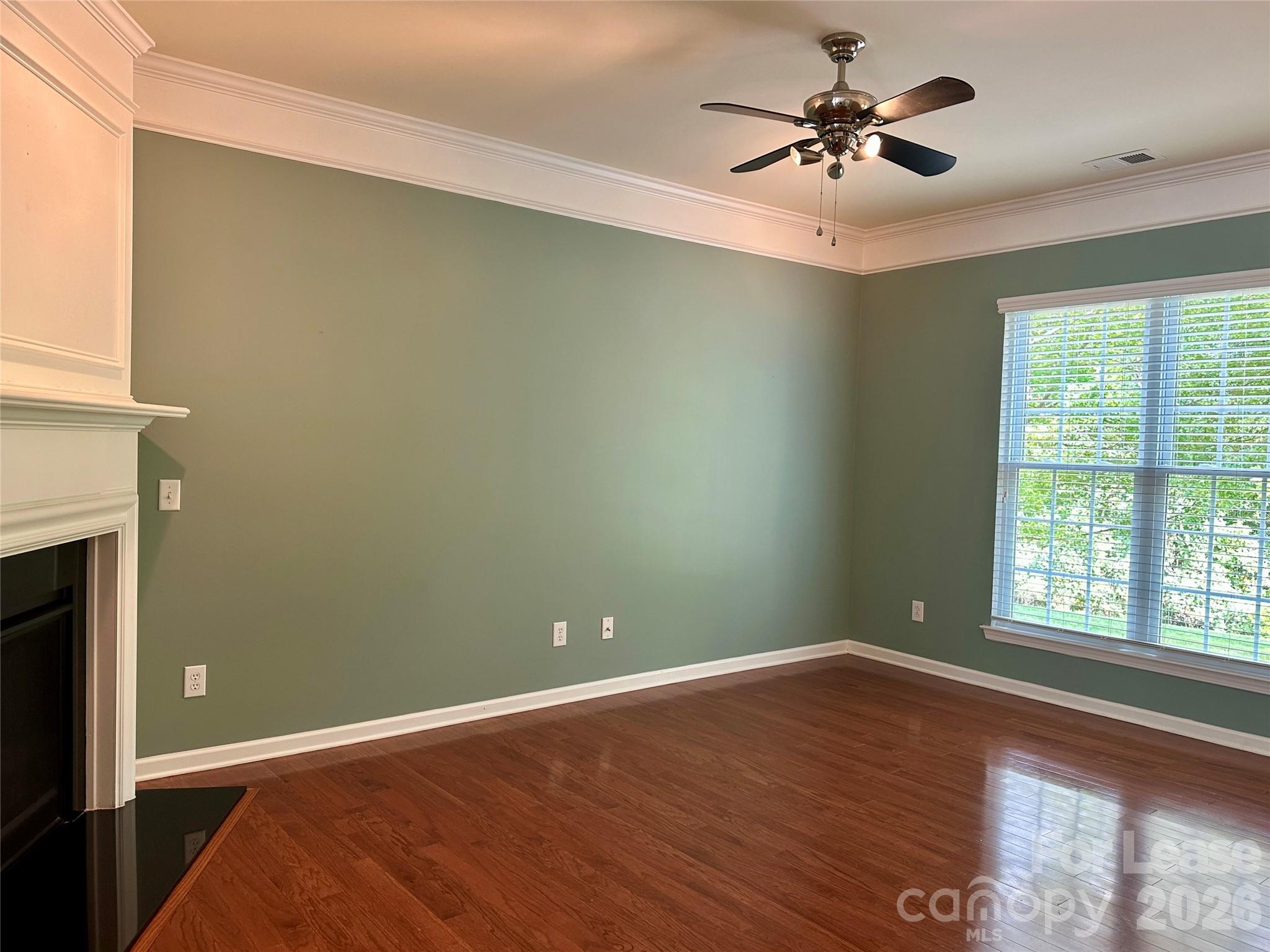 1104 Drayton Court Fort Mill, SC 29708 - Photo 6 of 20 a view of empty room with wooden floor and fan