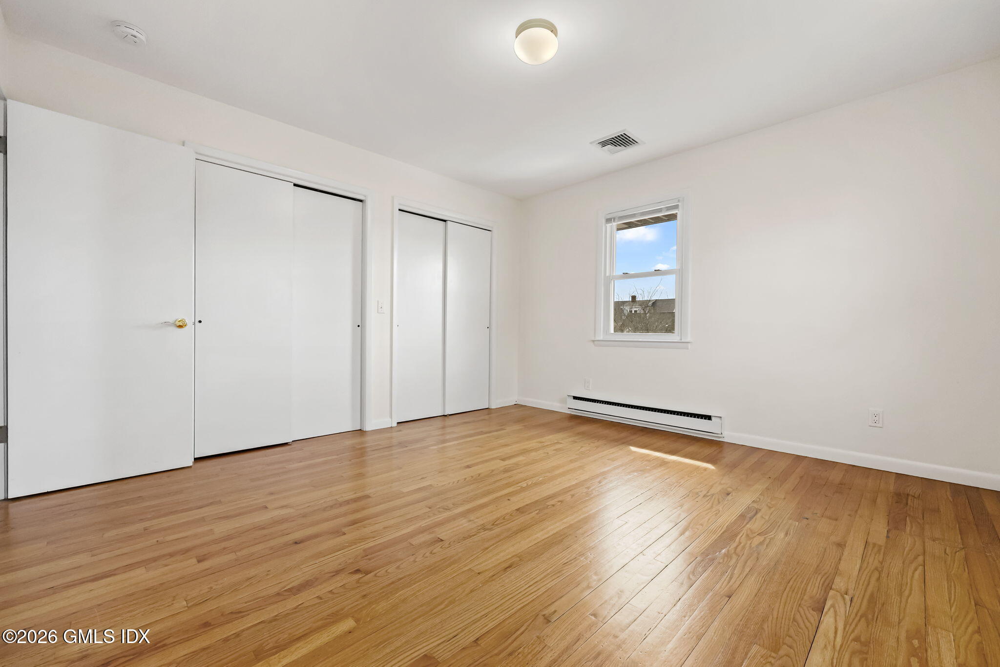 2 Grange Street Greenwich, CT 06830 - Photo 23 of 31 an empty room with wooden floor and windows