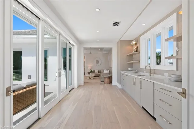 a large white room with a large window and furniture