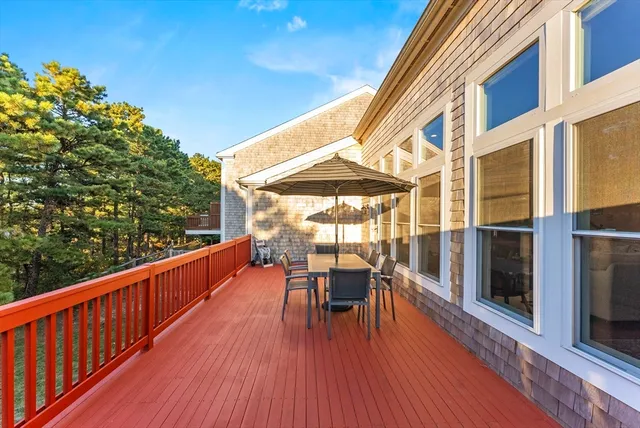 a balcony with furniture and wooden floor