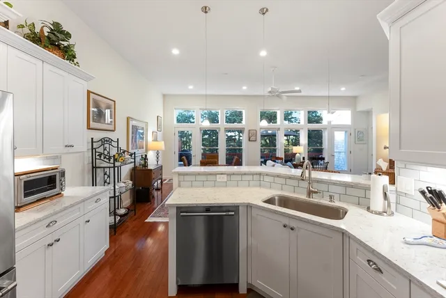 a kitchen with stainless steel appliances granite countertop a sink stove and cabinets