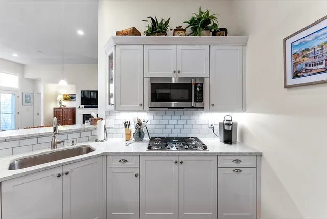 a kitchen with stainless steel appliances white cabinets and a sink