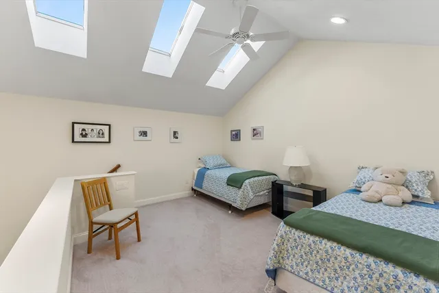 a bedroom with two beds and a chair