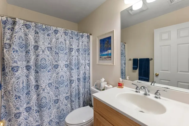 a bathroom with a sink toilet and mirror