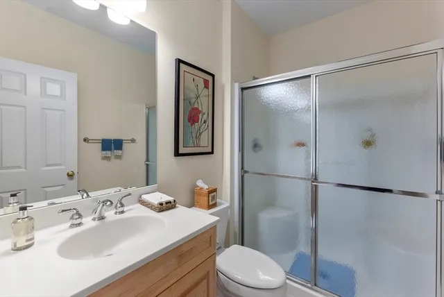 a bathroom with a sink toilet and shower