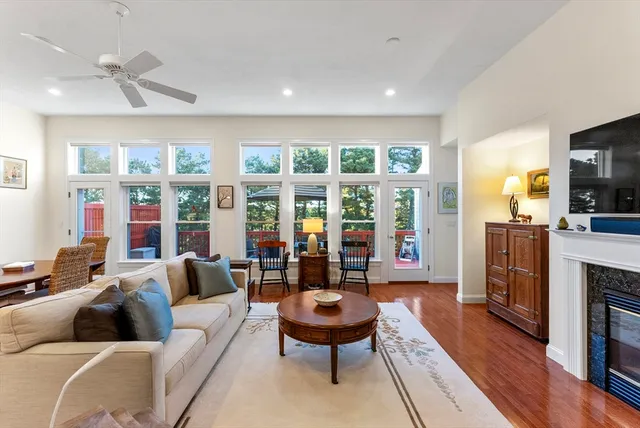 a living room with furniture fireplace and flat screen tv