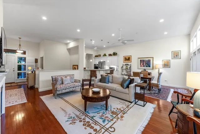a living room with furniture kitchen view and a table