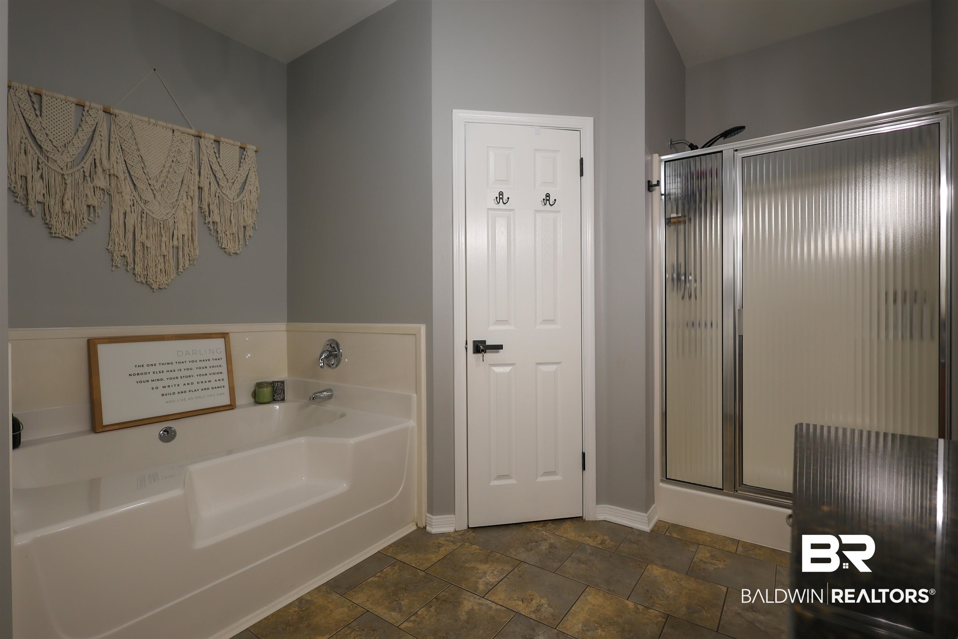 5151 Beatrice Road Gulf Shores, AL 36542 - Photo 23 of 50 Full bathroom with a shower stall, a garden tub, and dark stone finish flooring
