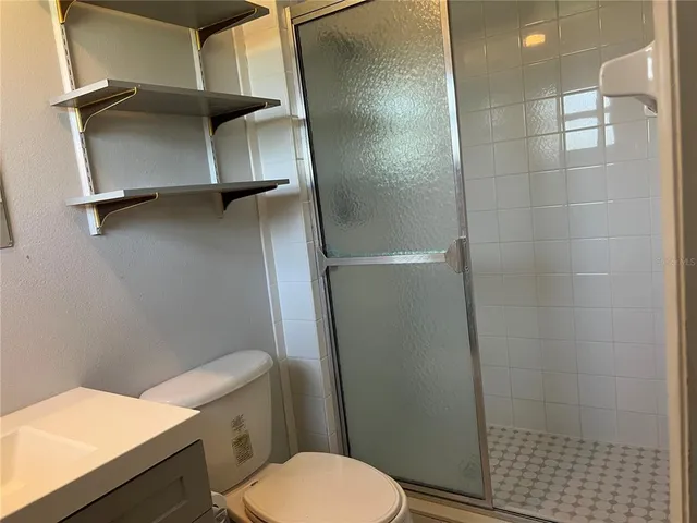 a bathroom with a toilet and a shower