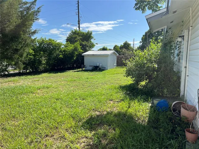 a backyard of a house with table and chairs