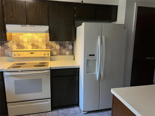 a kitchen with stainless steel appliances a refrigerator and a stove