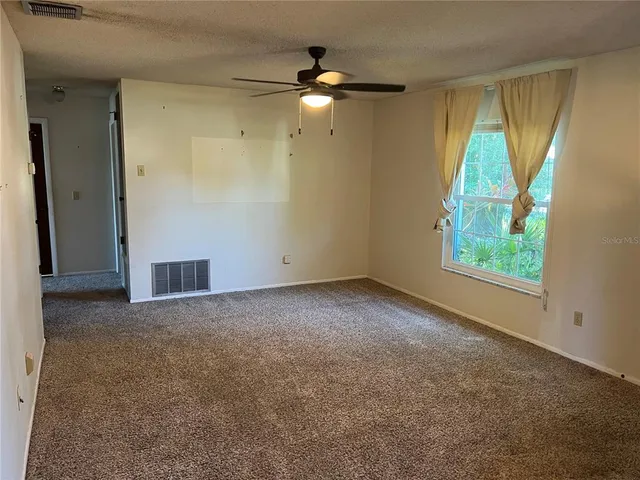 an empty room with windows and closet