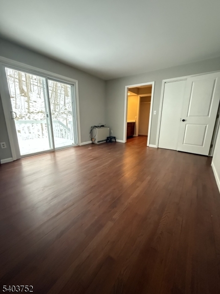 118 Statesville Quarry Road Lafayette, NJ 07848 - Photo 13 of 19 an empty room with wooden floor and windows