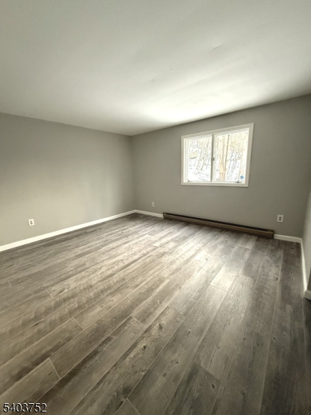 118 Statesville Quarry Road Lafayette, NJ 07848 - Photo 18 of 19 an empty room with wooden floor and windows