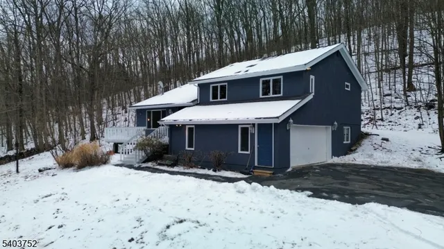 a large kitchen with stainless steel appliances granite countertop a sink a stove a counter space and cabinets