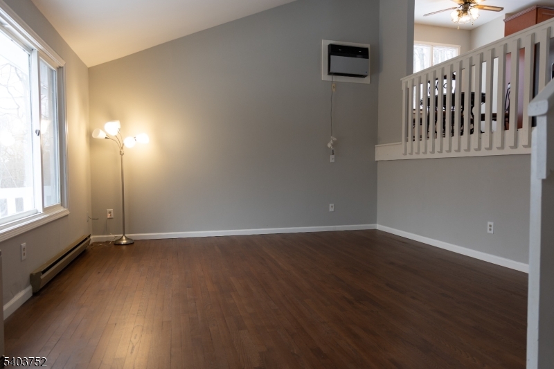118 Statesville Quarry Road Lafayette, NJ 07848 - Photo 4 of 19 an empty room with wooden floor and windows