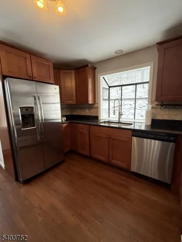 a kitchen with granite countertop a stove and a microwave oven