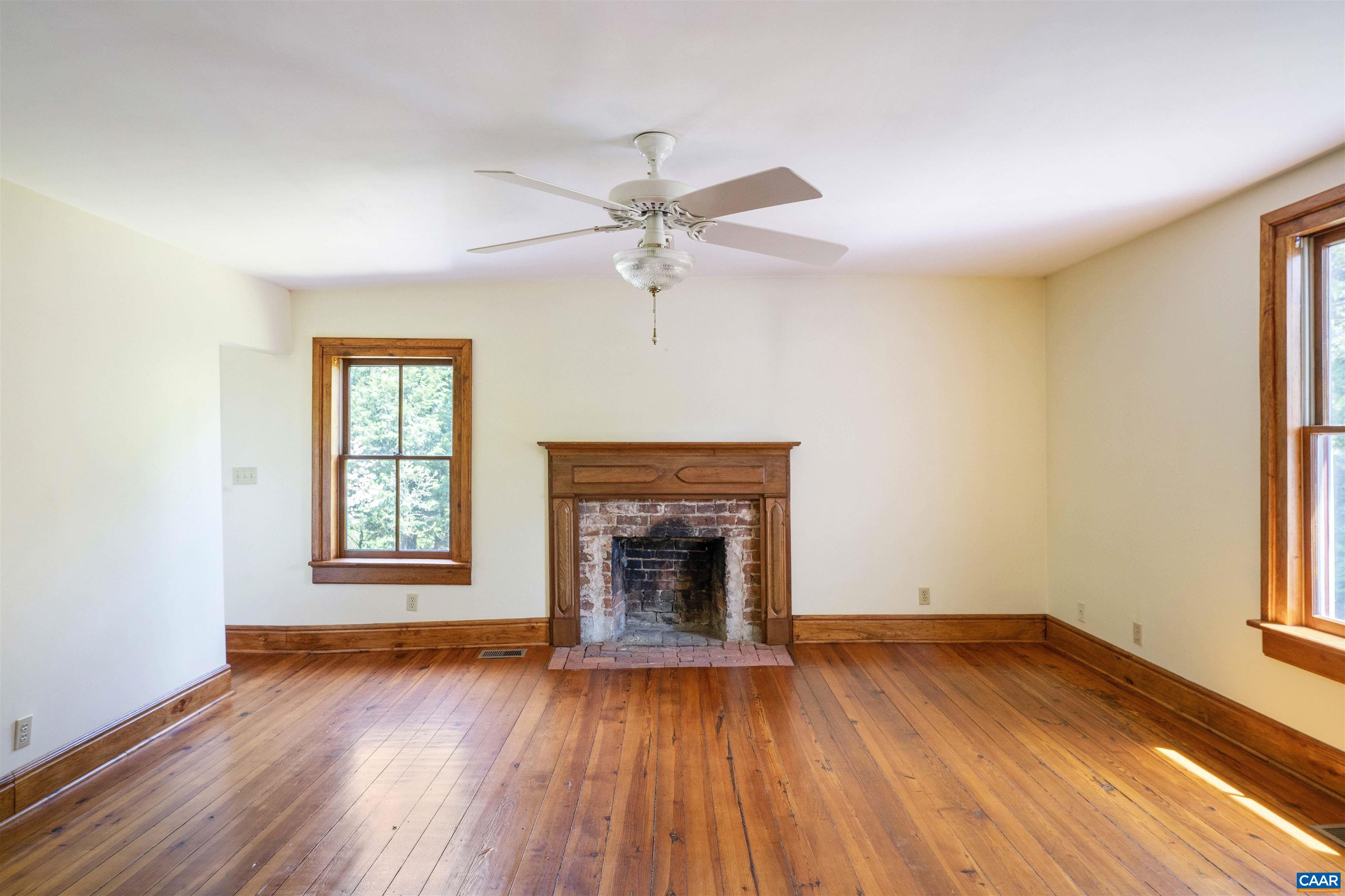 1888 Craigs Store Road Afton, VA 22920 - Photo 30 of 73 an empty room with wooden floor fireplace and windows