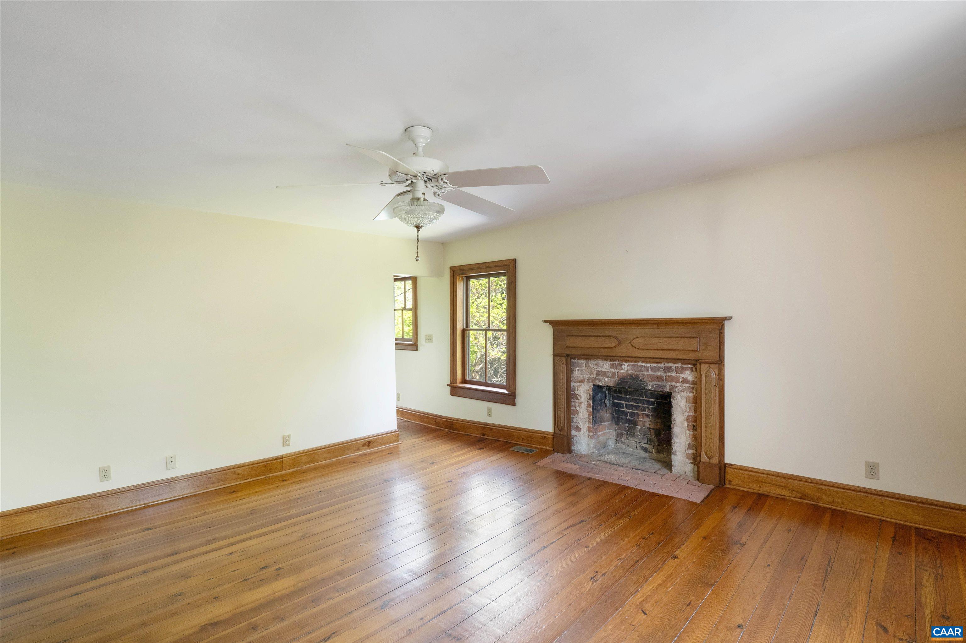 1888 Craigs Store Road Afton, VA 22920 - Photo 34 of 73 an empty room with wooden floor fireplace and windows