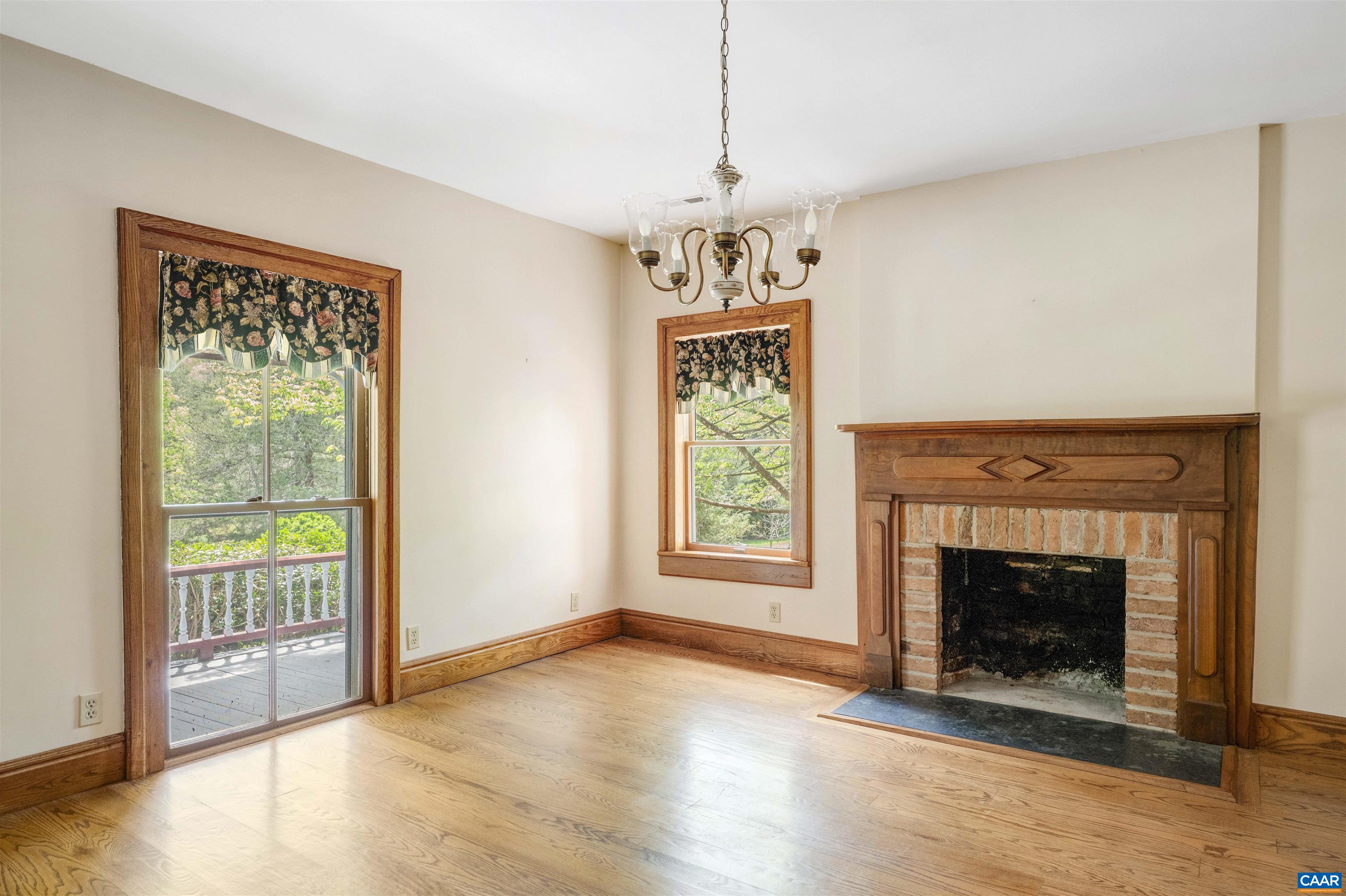 1888 Craigs Store Road Afton, VA 22920 - Photo 6 of 73 a view of an empty room with wooden floor fireplace and a window