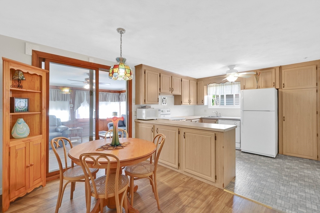 76 Regal Street Springfield, MA 01118 - Photo 11 of 38 a dining hall with stainless steel appliances granite countertop a dining table chairs and a refrigerator