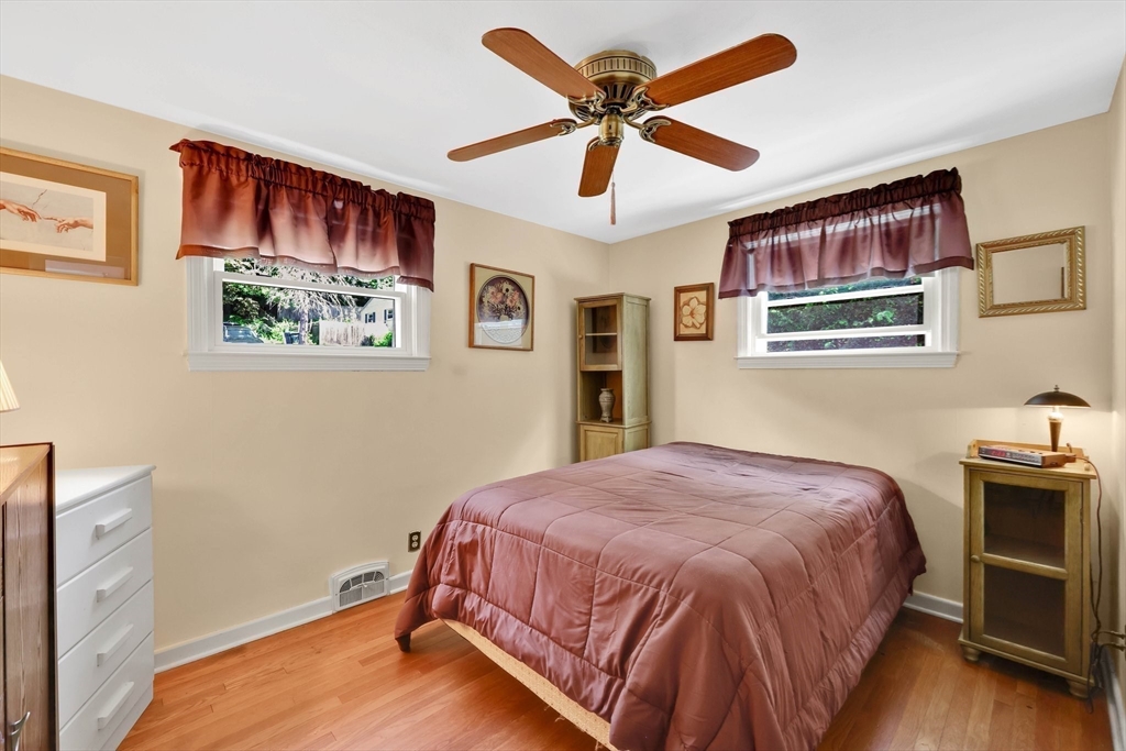 76 Regal Street Springfield, MA 01118 - Photo 16 of 38 a bedroom with a bed and a chandelier