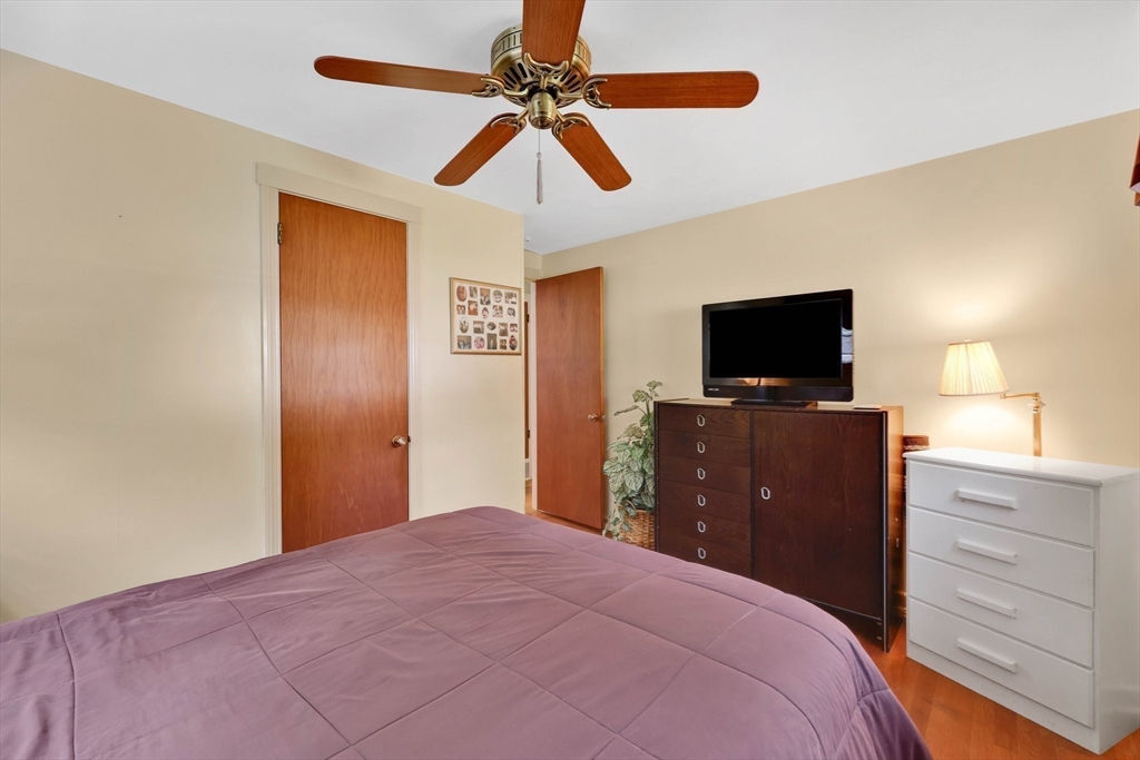 76 Regal Street Springfield, MA 01118 - Photo 17 of 38 a bedroom with a bed and a flat tv screen on dresser