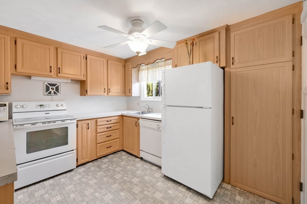 76 Regal Street Springfield, MA 01118 - Photo 8 of 38 a kitchen with a refrigerator sink stove and cabinets