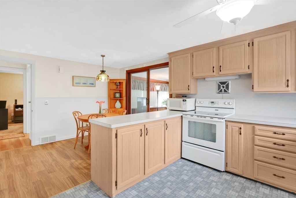 76 Regal Street Springfield, MA 01118 - Photo 10 of 38 a kitchen with granite countertop white cabinets and white appliances