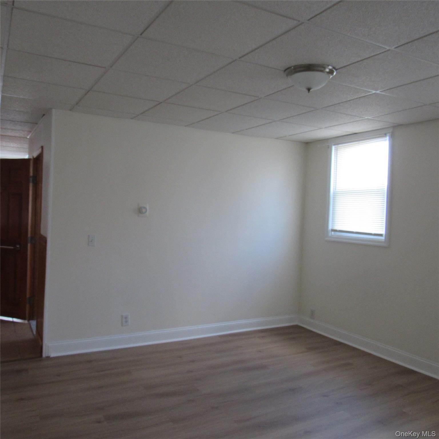 35 Taylor Avenue, Unit 2 Poughkeepsie, NY 12601 - Photo 11 of 19 Living room with a paneled ceiling and dark wood-style floors
