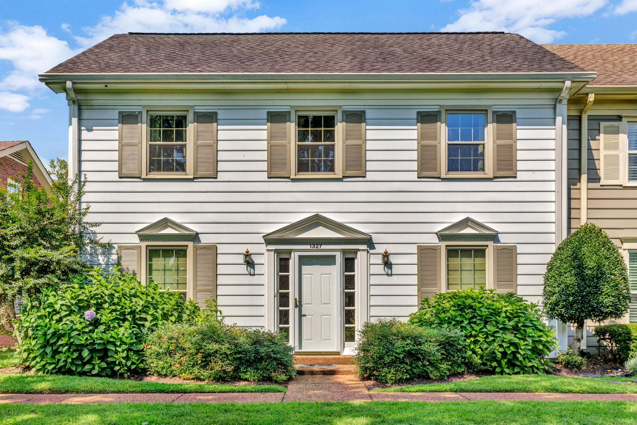 1327 General George Patton Road Nashville, TN 37221 - Photo 1 of 36 a front view of a house with a yard and trees
