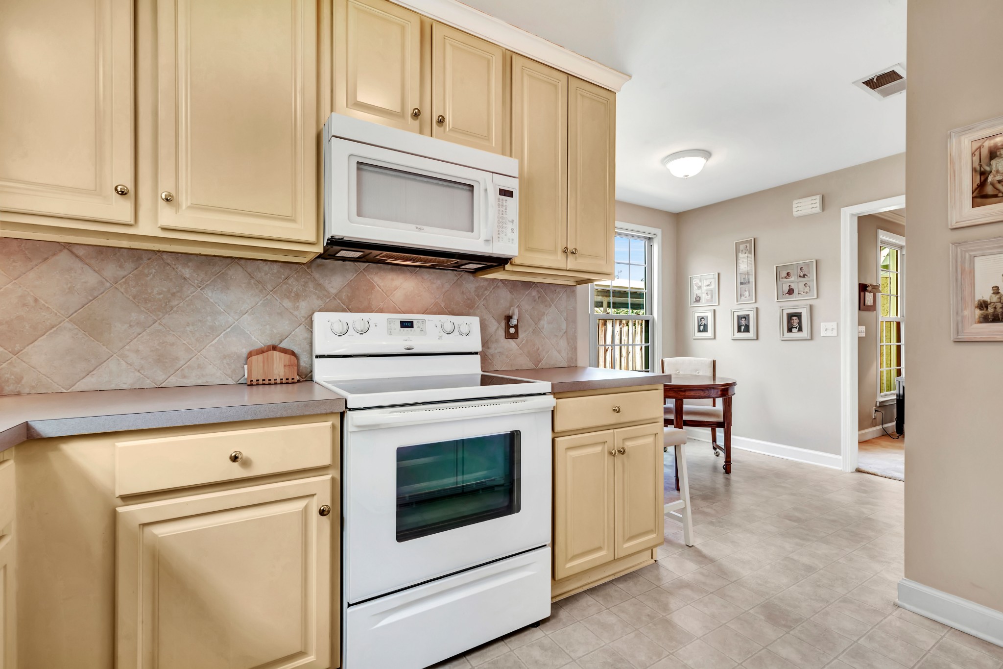 1327 General George Patton Road Nashville, TN 37221 - Photo 8 of 36 a kitchen with stainless steel appliances granite countertop white cabinets and a stove top oven