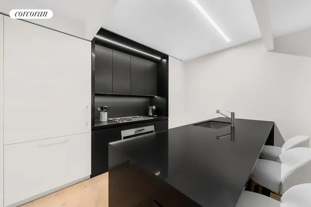 a kitchen with a refrigerator and a stove