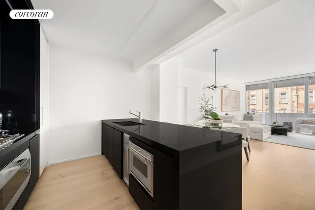 a kitchen with granite countertop a sink stove and cabinets