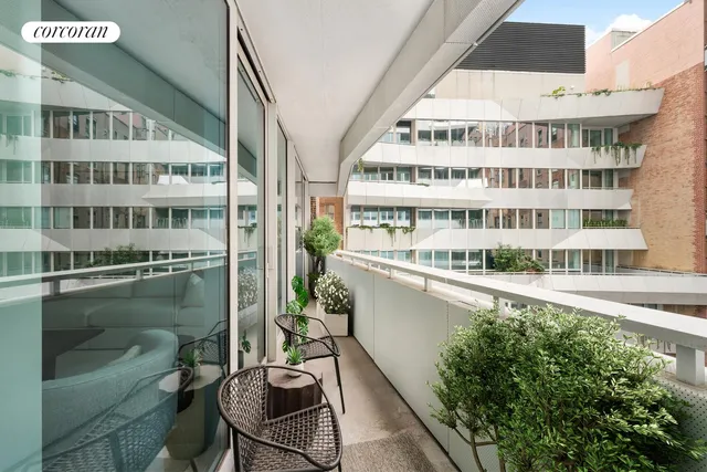 a view of balcony with a potted plant and barbeque oven