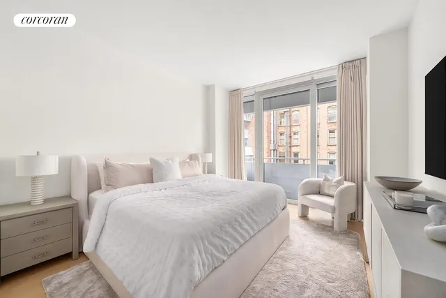 a bedroom with a bed and a large window