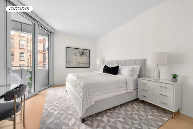 a bedroom with a large bed and a window