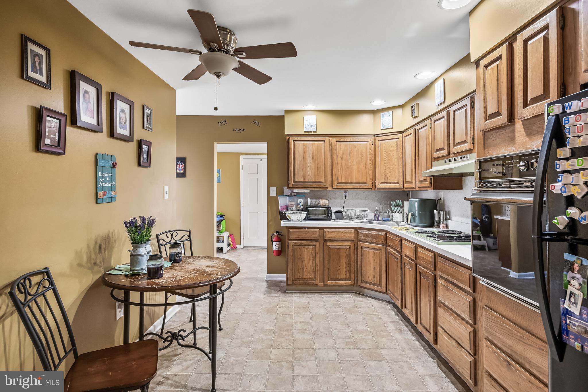 2276 Winslow Road Williamstown, NJ 08094 - Photo 11 of 39 a kitchen with stainless steel appliances granite countertop a refrigerator a sink dishwasher a stove and white cabinets with wooden floor