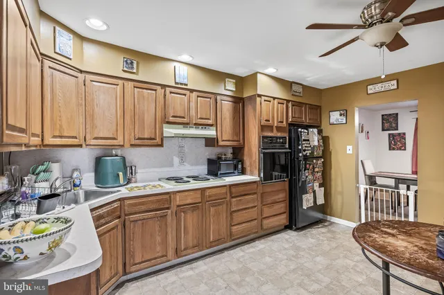 a kitchen with stainless steel appliances granite countertop a refrigerator and cabinets