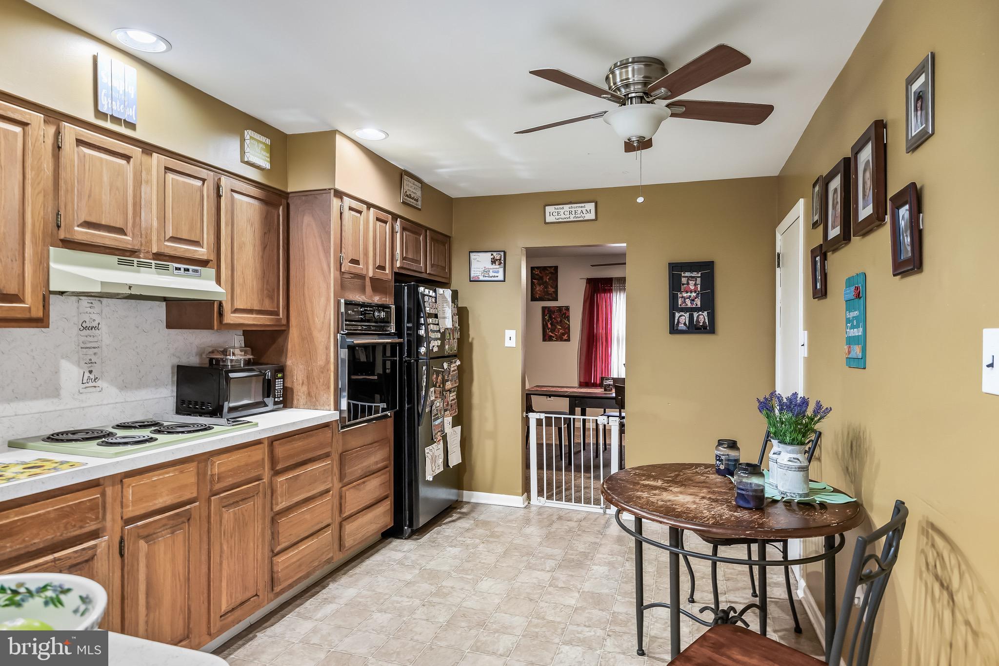 2276 Winslow Road Williamstown, NJ 08094 - Photo 13 of 39 a kitchen with stainless steel appliances kitchen island granite countertop a refrigerator a stove a sink dishwasher and a dining table with wooden floor