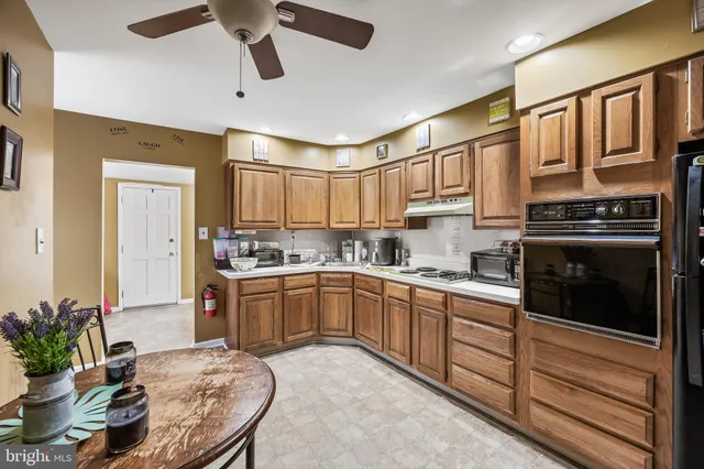 a kitchen with stainless steel appliances granite countertop a stove sink and cabinets