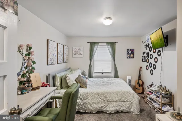 a bedroom with bed and a window