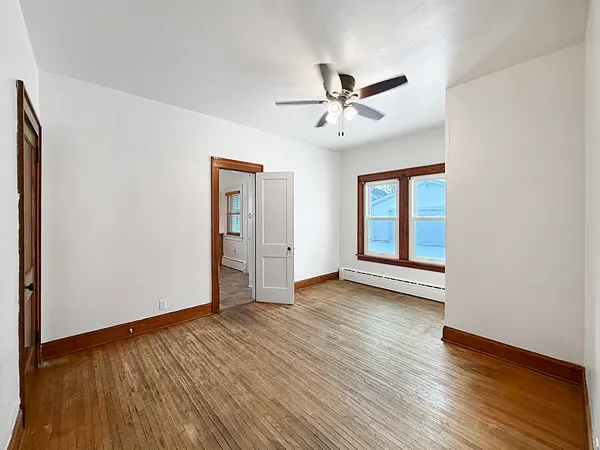 wooden floor in an empty room with a window