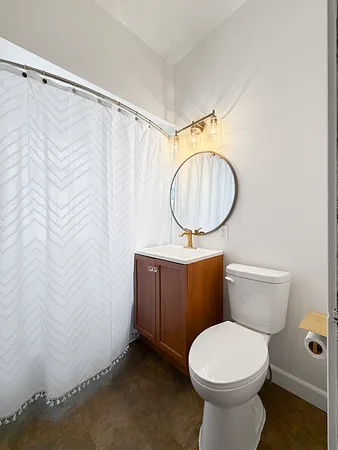 a bathroom with a toilet a sink and a shower