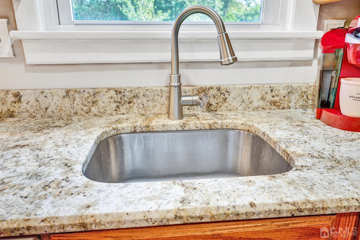 254 Manalapan Road Spotswood, NJ 08884 - Photo 11 of 41 a view of a sink vanity granite counter top and a wooden floor