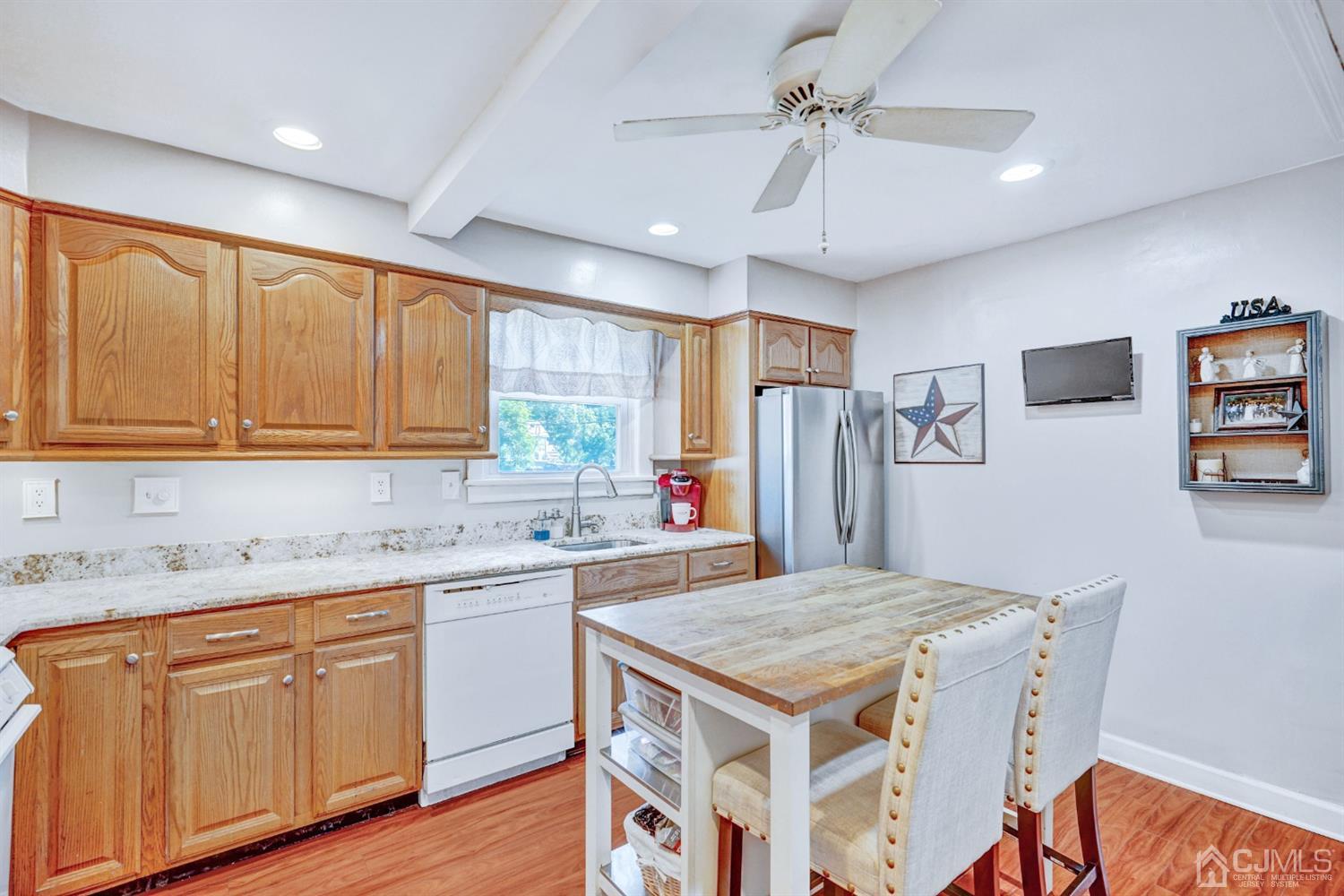 254 Manalapan Road Spotswood, NJ 08884 - Photo 12 of 41 a kitchen with kitchen island a sink stove and refrigerator