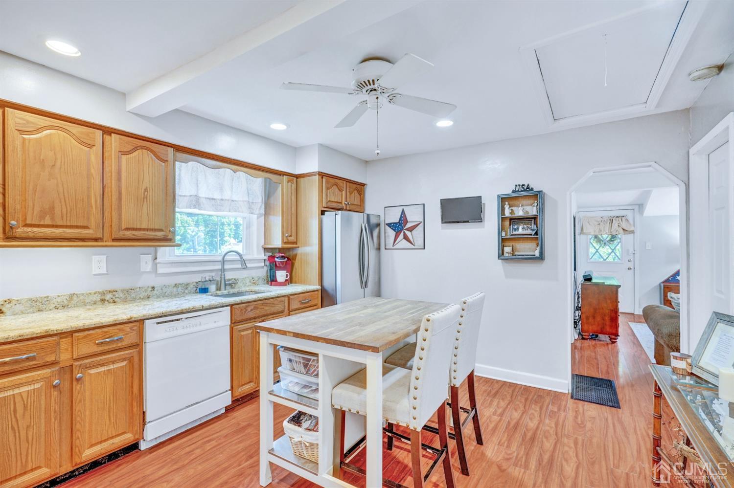 254 Manalapan Road Spotswood, NJ 08884 - Photo 14 of 41 a kitchen with stainless steel appliances granite countertop a stove a sink dishwasher and a refrigerator with wooden floor