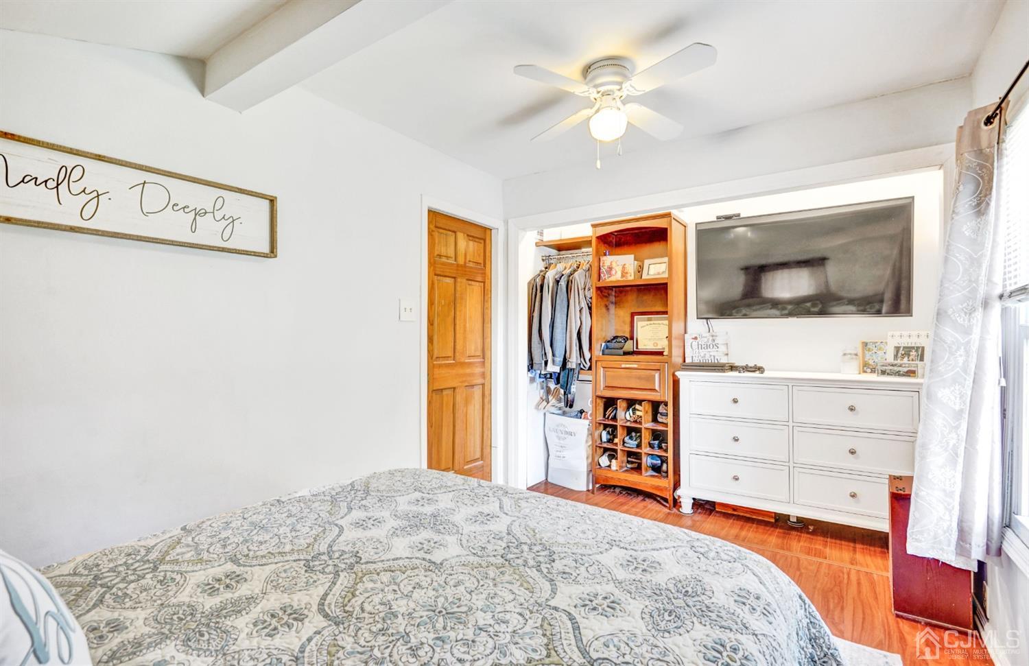 254 Manalapan Road Spotswood, NJ 08884 - Photo 16 of 41 a bedroom with a bed and a flat tv screen in it