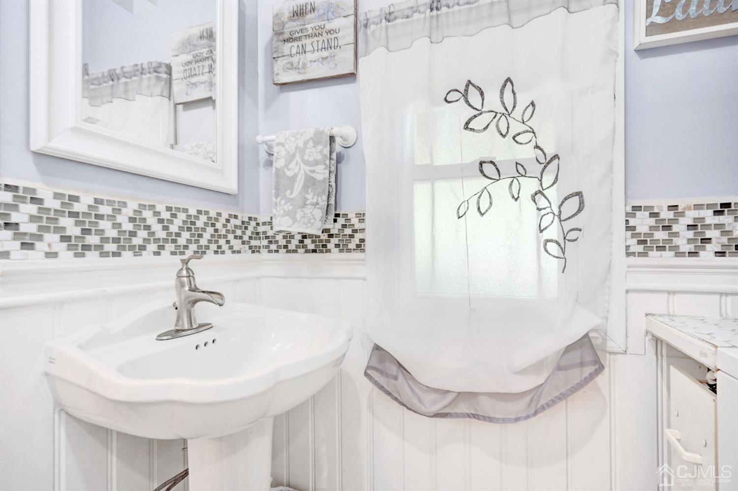 254 Manalapan Road Spotswood, NJ 08884 - Photo 18 of 41 a bathroom with a sink and a mirror