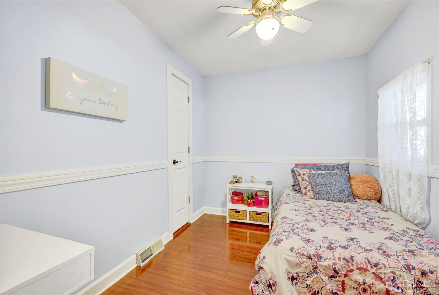 254 Manalapan Road Spotswood, NJ 08884 - Photo 21 of 41 a bedroom with a bed and a chandelier